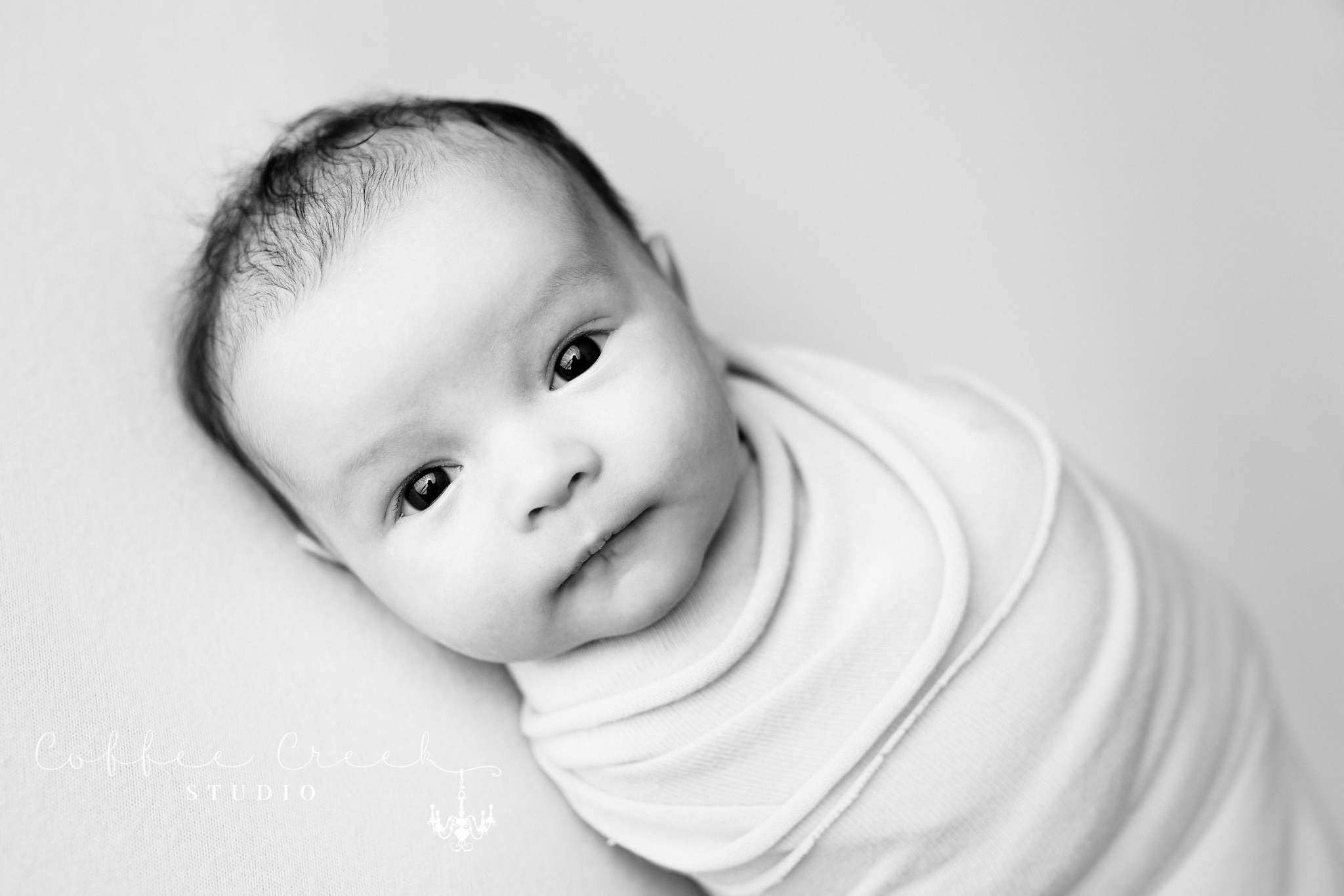 black and white image of awake newborn baby