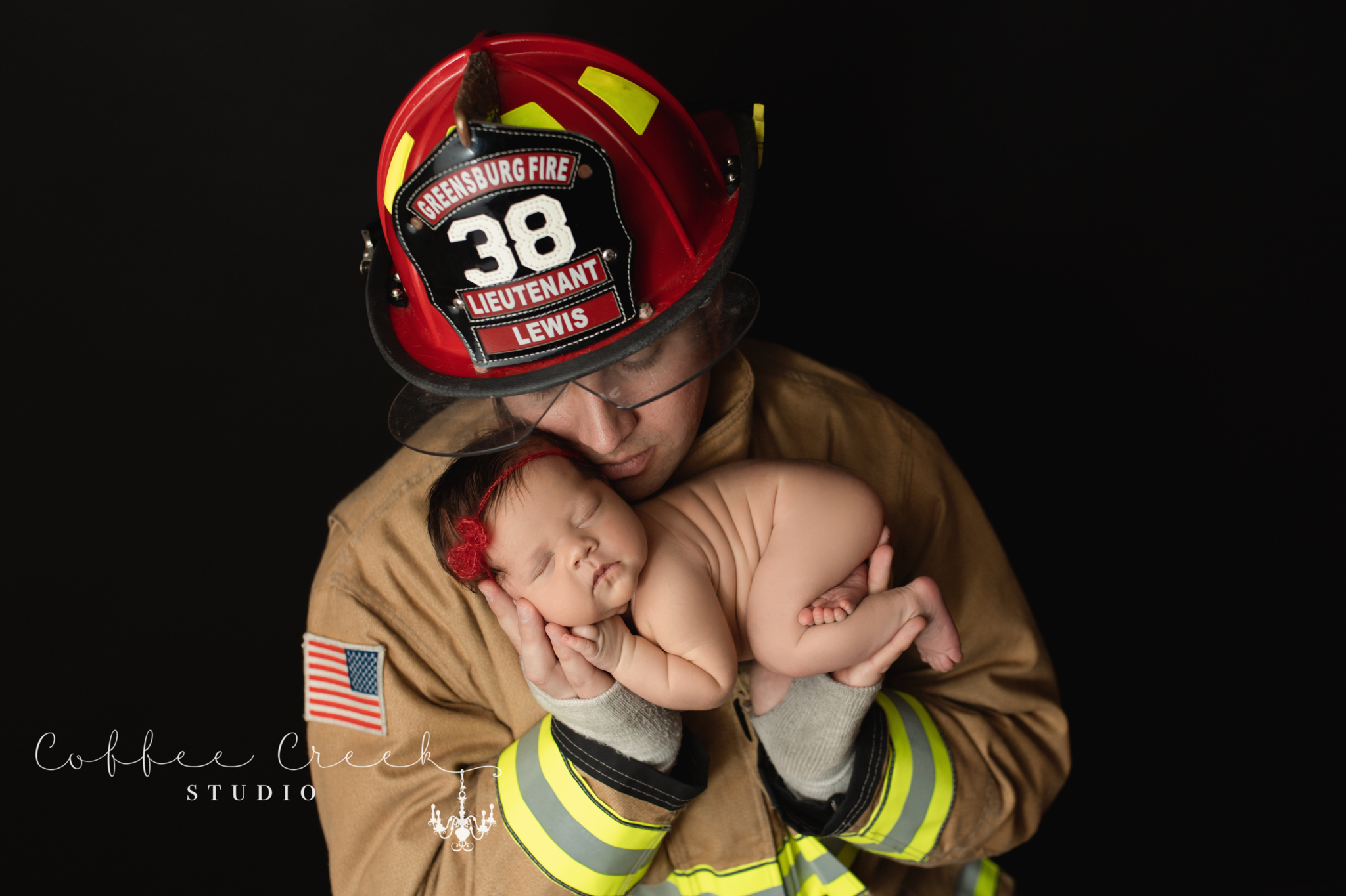 fireman holding newborn baby girl