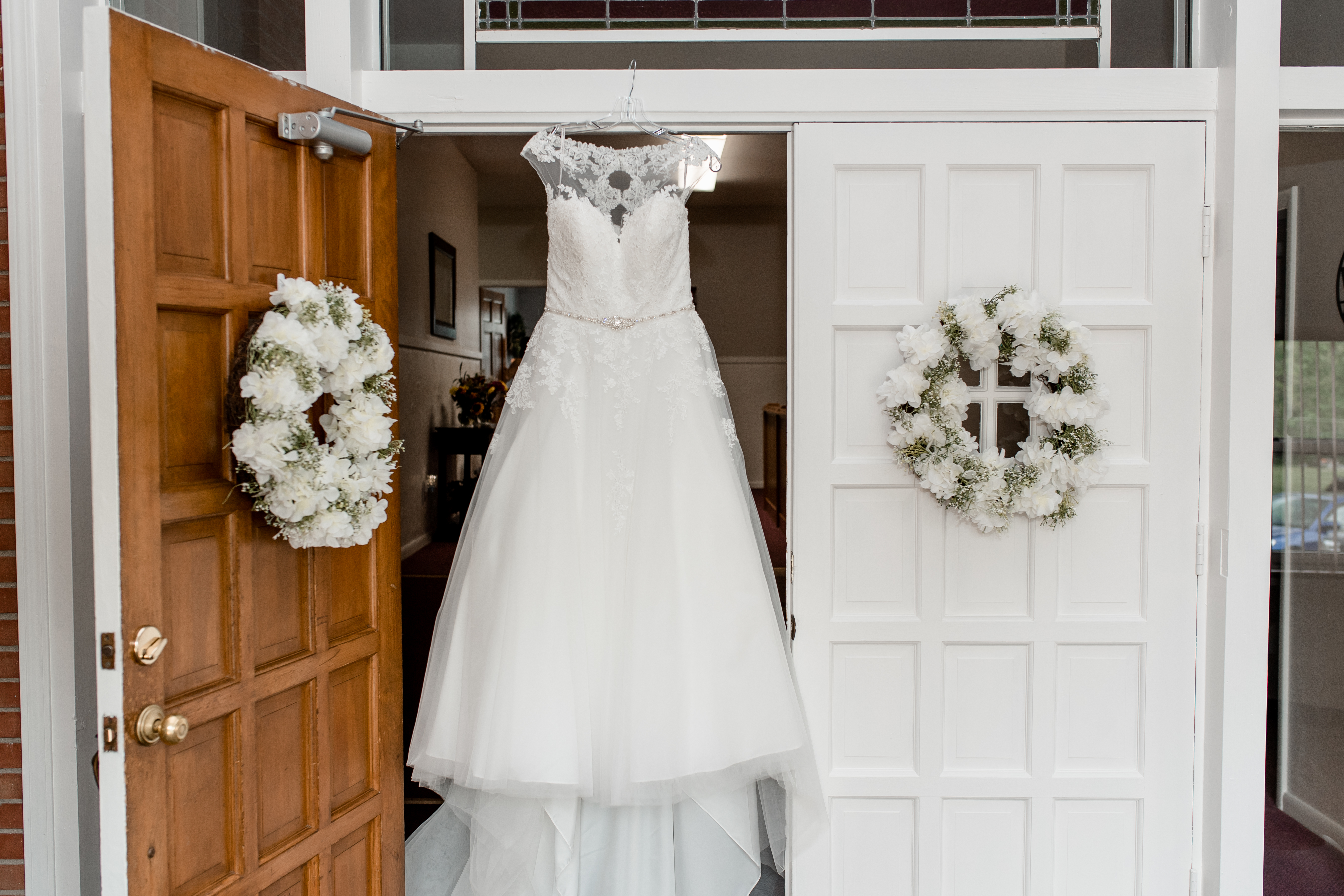 wedding dress hanging in door frame