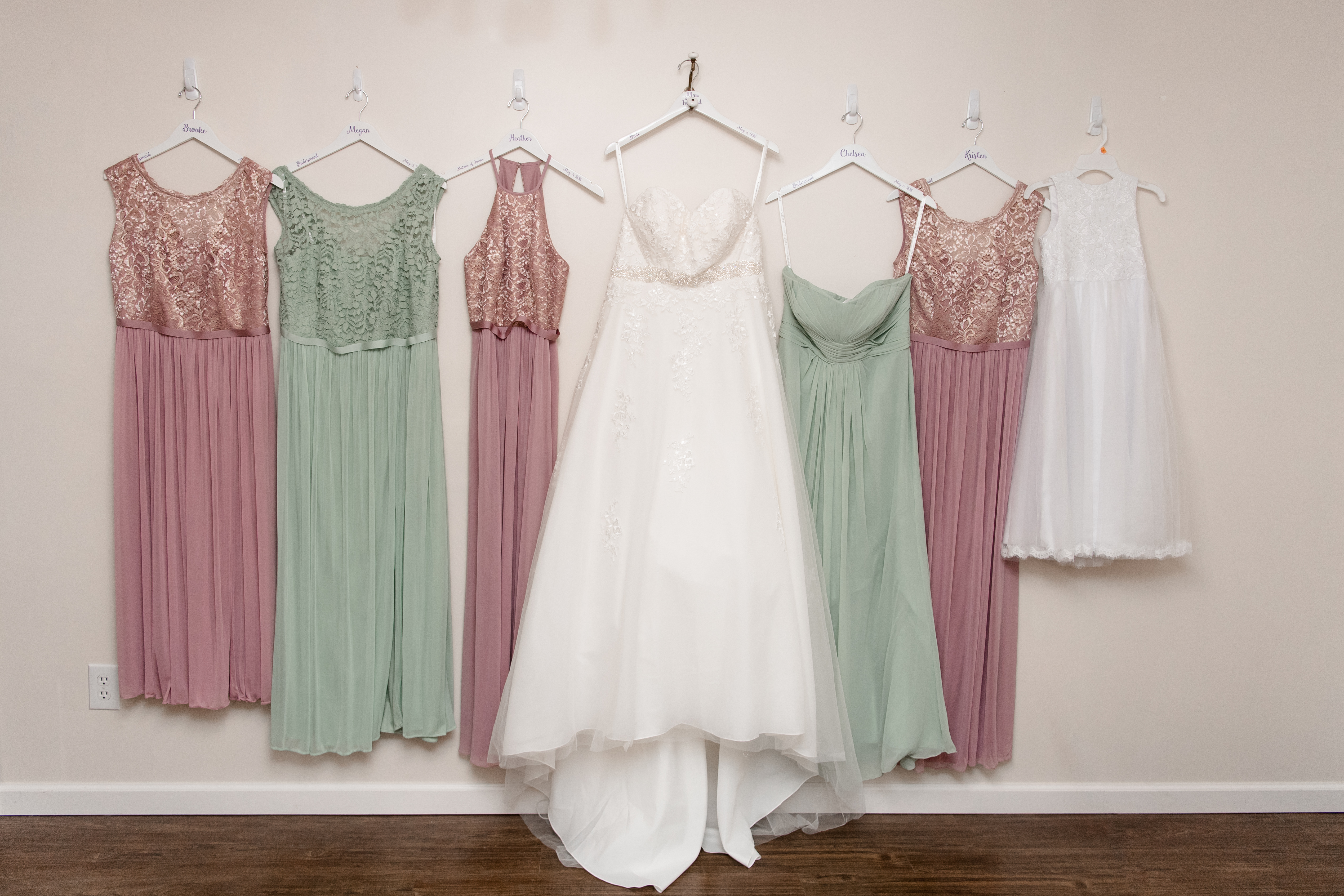 bridal gown and bridal party dresses hanging up