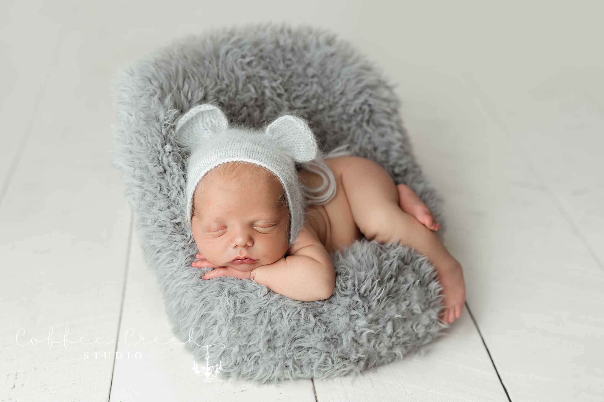 sleeping newborn in rat bonnet