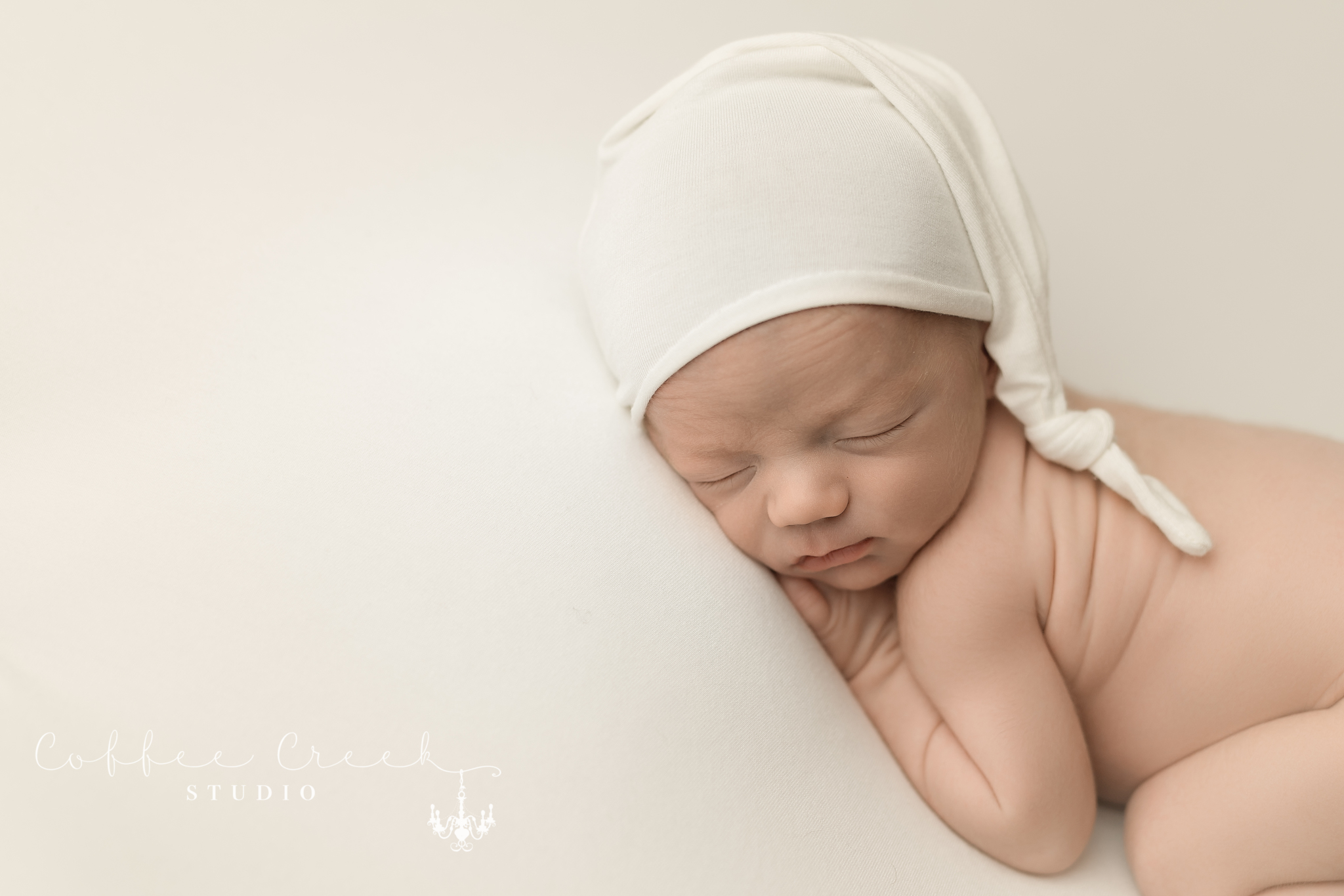 posed newborn sleeping in rip van winkle cap