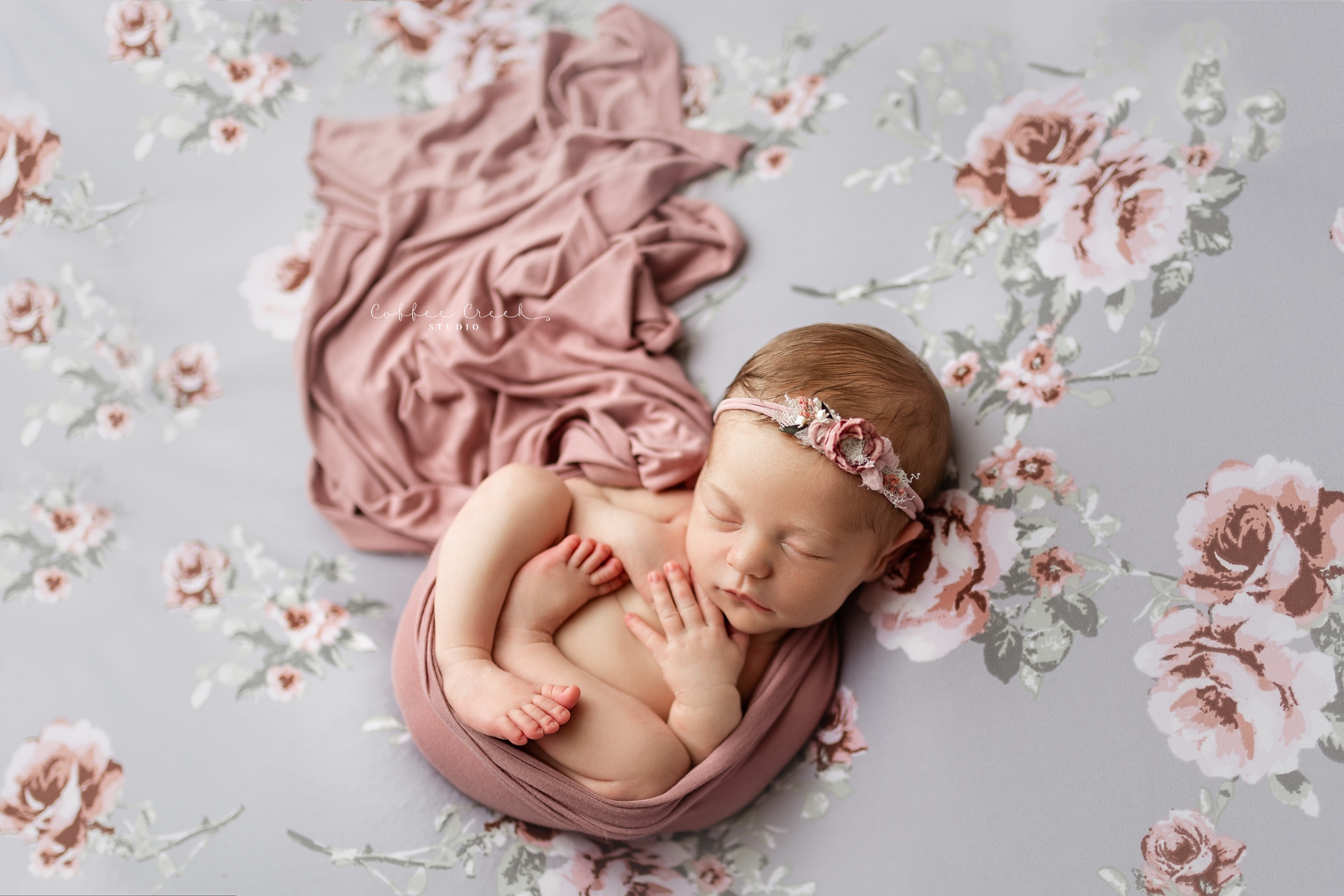 newborn baby girl on floral backdrop
