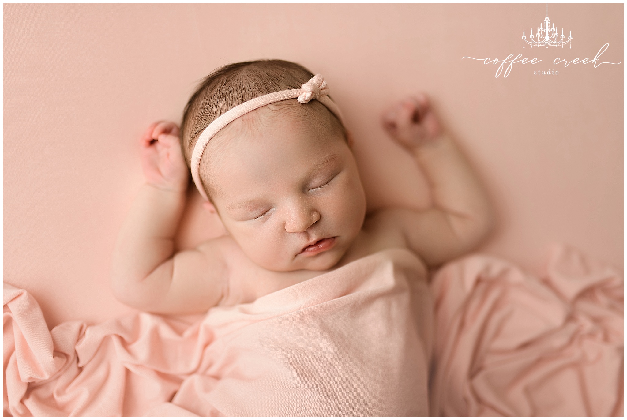 newborn photographer baby in pink blanket